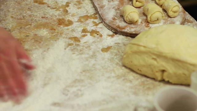 Woman working with dough. making homemade croissants