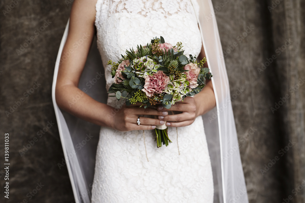 Wall mural Bride holding wedding bouquet, close up