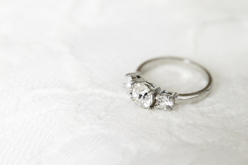 Diamond wedding ring on white, close up