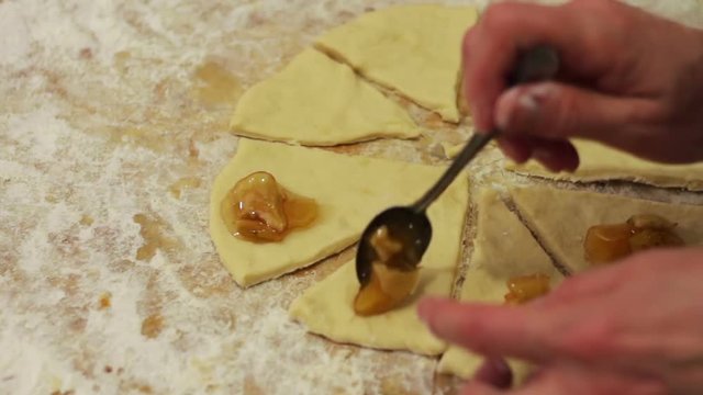 Woman working with dough. making homemade croissants