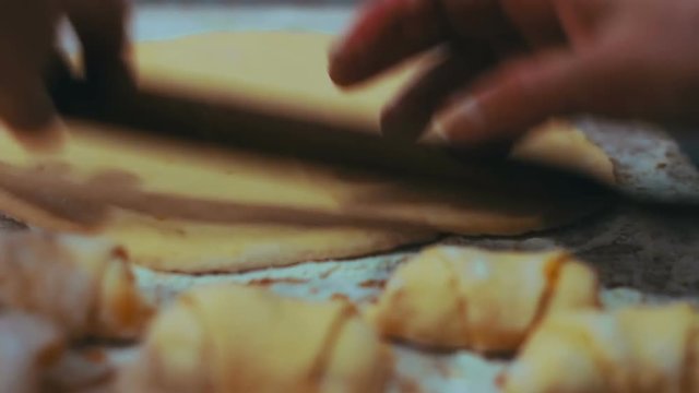 Woman working with dough. making homemade croissants