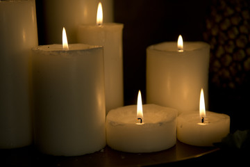Fototapeta na wymiar The wax candles with fire