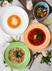 Different soups in a still-life on top for a menu of borsch, cream soup, gospachu, Japanese soup with shrimps,