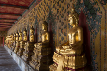 Series of golden statue of Gautama Buddha in Wat Arun temple in Bangkok, Thailand. Symbol of Buddhism.