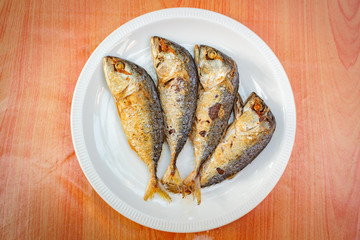 Fried mackerel in white plate.