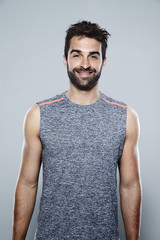 Athlete in grey vest, smiling