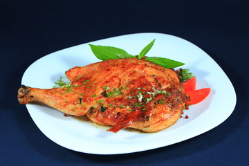 Baked chicken on white plate.