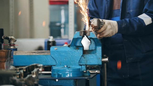 Circular saw sparkles -mechanic grinding metal detail hamstrung automobile repairing, close up view