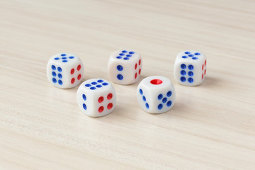 Five dice on a wooden table