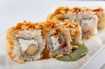 sushi roll with tuna, Philadelphia cheese, flying fish caviar, peanuts