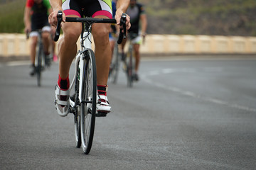 Naklejka na ściany i meble Cycling competition,cyclist athletes riding a race at high speed