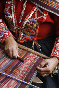 Quechua women weaving a traditional textile, Cuzco, Peru.