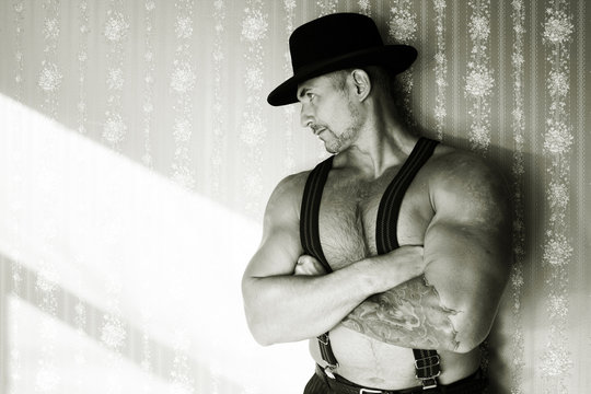 Muscular macho in a felt hat black and white photo