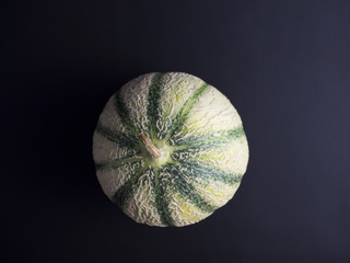 Cantaloupe melon isolated on dark background