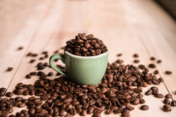 Coffee. Coffee beans. Coffee cup full of coffee beans. Toned image.