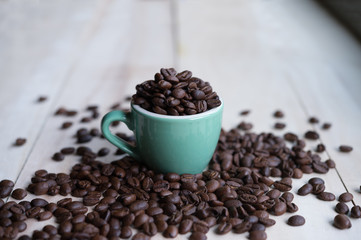 Coffee. Coffee beans. Coffee cup full of coffee beans. Toned image.