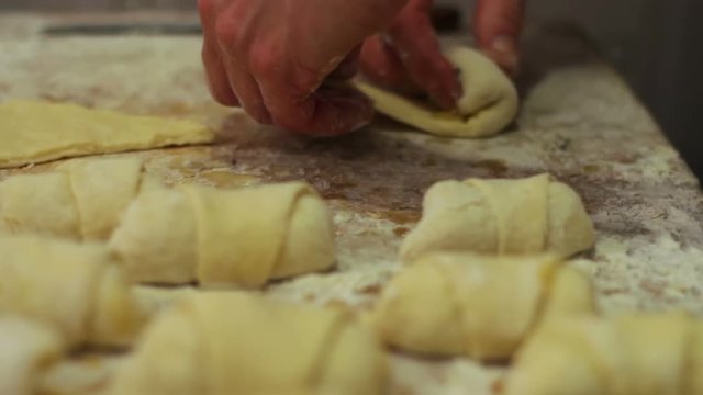 Woman working with dough. making homemade croissants