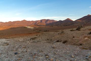 Stone desert with white houses. Desert landscape at sunrise in the national park Cabo de Gata in Andalusia