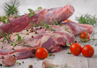 Fresh and raw meat. Leg of lamb on wood background