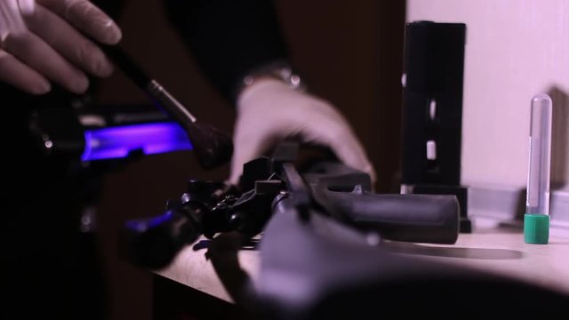 CSI Expert at crime scene exploring rifle