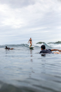 Indonesia, Java, surfers in the ocean