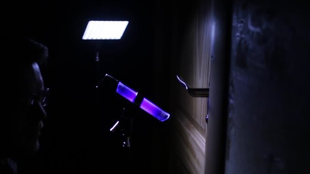 CSI Expert at crime scene with UV lamp checking fingerpints3