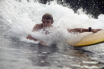 Indonesia, Java, water splashing over man surfing