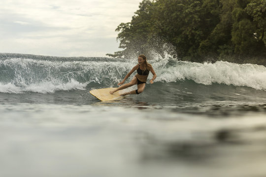 Indonesia, Java, happy woman surfing