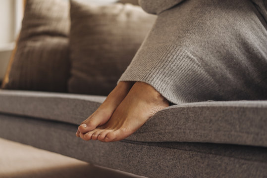Feet of woman on couch
