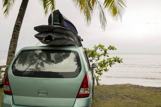 Indonesia, Java, car with surfboards on the roof at the coast