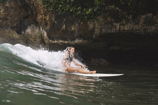 Indonesia, Java, happy woman surfing
