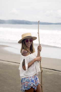 Indonesia, Java, portrait of smiling woman standing on the beach
