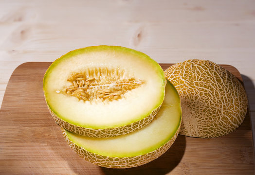 Fresh ripe melon cut on a cutting wooden board