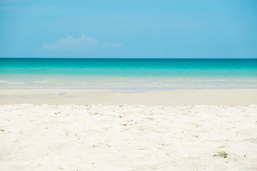 Fototapeta na wymiar Sand beach with aqua sea water in background