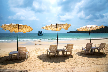 White umbrellas in cloudy day on beautiful beach at Samed island, Thailand