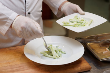 Chef is serving cucumber salad