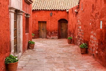 Fototapeta na wymiar Typical street and painted buildings in historic Santa Catalina Monastery, Arequipa, Peru
