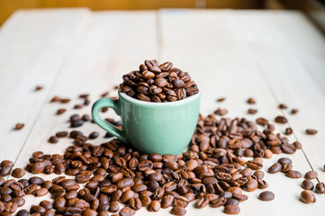 Coffee. Coffee beans. Coffee cup full of coffee beans. Toned image.