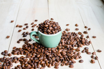 Coffee. Coffee beans. Coffee cup full of coffee beans. Toned image.