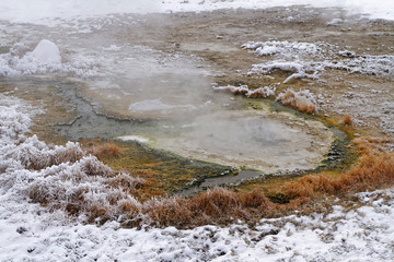 A pool of hot waters in Black sand basin, winter landscape, Yellowstone National Park