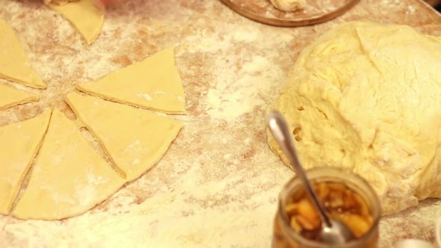 Woman working with dough. making homemade croissants