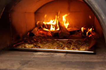 Apples being roasted in wood stove