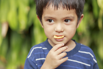 Boy eating fish crisp