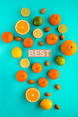 Photo of citrus fruits, lemons, oranges, limes, mandarines, nuts, view from above, cyan background, isolated