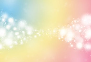 Pastel color sparkles glitter defocused rays lights bokeh abstract holiday background.