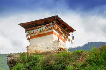 shrine with a lot of colorful prayer flags on a mountain in Bhutan