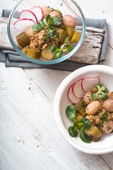 Salad with potatoes, cucumber and radish in a glass or ceramic bowls
