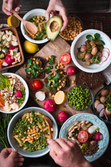 Feast with vegetable salads, fruits and sandwiches