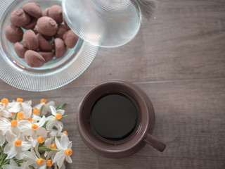 Fototapeta na wymiar White flower,coffee and cookies on wooden