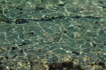 Dazzling pebbles under the waters of Mediterranean sea. Creta, Greece.